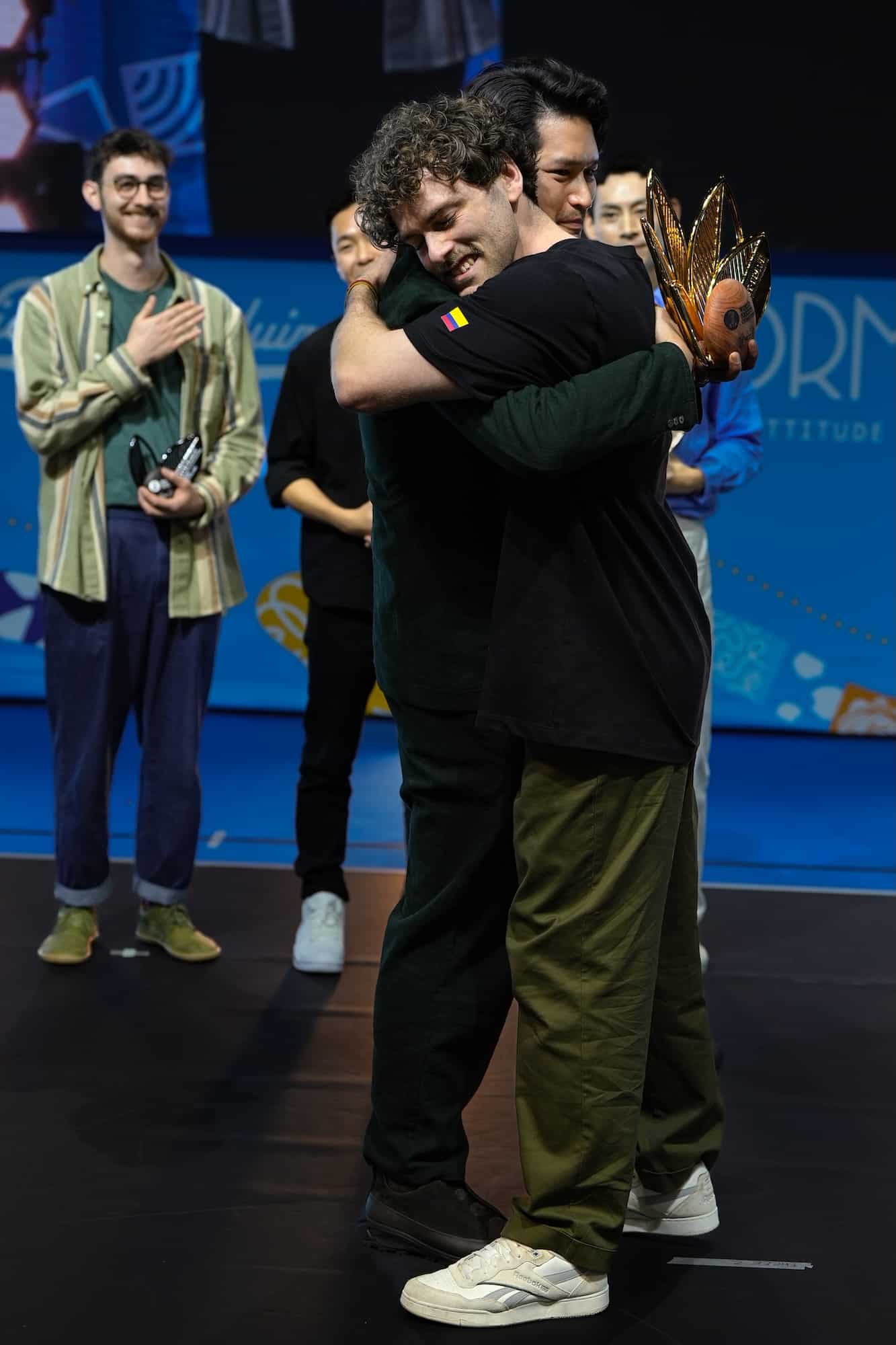 Mikael Jasin and Jack embrace during the WBC trophy presentation. Image: Specialty Coffee Association.